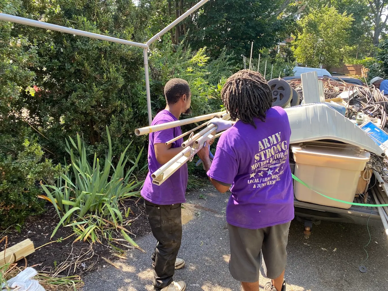 Army Strong crew loading scrap onto a trailer for junk removal
