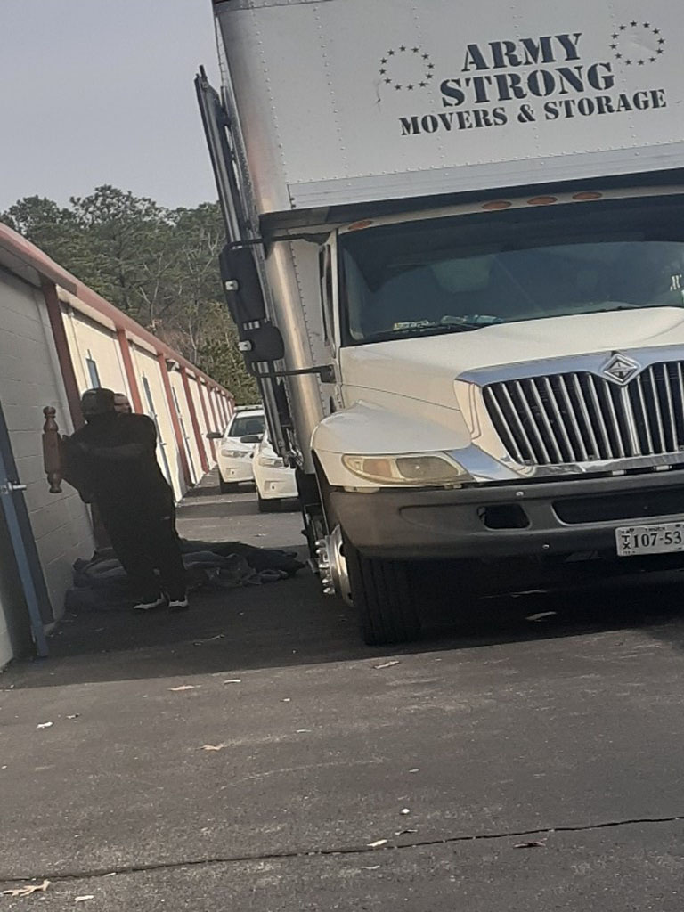 Army Strong truck backed into a storage facility
